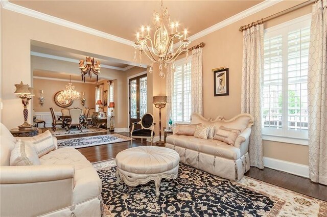 living room with a wealth of natural light, wood finished floors, and an inviting chandelier