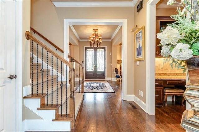 entrance foyer with dark wood-style floors, french doors, and stairs