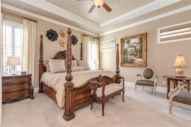 bedroom with light carpet, multiple windows, ornamental molding, and a raised ceiling