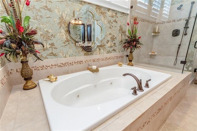 full bath featuring a whirlpool tub, a stall shower, and wallpapered walls