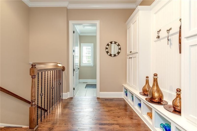 mudroom with baseboards, dark wood finished floors, and crown molding