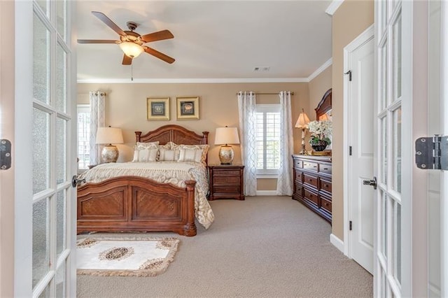 bedroom with multiple windows, french doors, crown molding, and light colored carpet