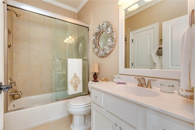 full bath featuring toilet, ornamental molding, enclosed tub / shower combo, vanity, and tile patterned floors