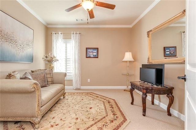 sitting room with light carpet, visible vents, baseboards, ceiling fan, and ornamental molding