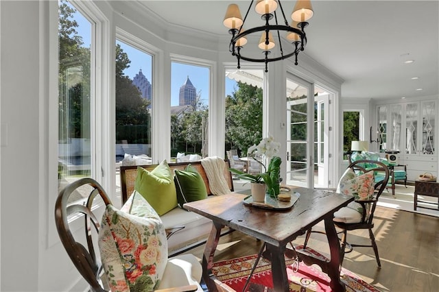 sunroom / solarium featuring plenty of natural light and a chandelier