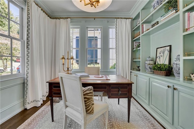 office area featuring crown molding, dark wood-type flooring, and built in shelves