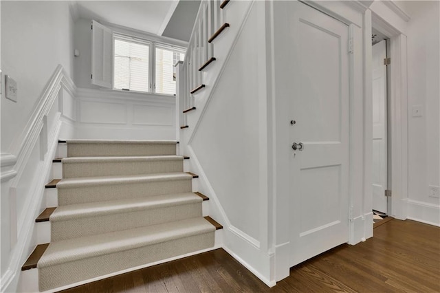 stairway featuring wood-type flooring