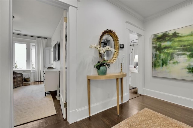 foyer entrance featuring crown molding and dark hardwood / wood-style floors