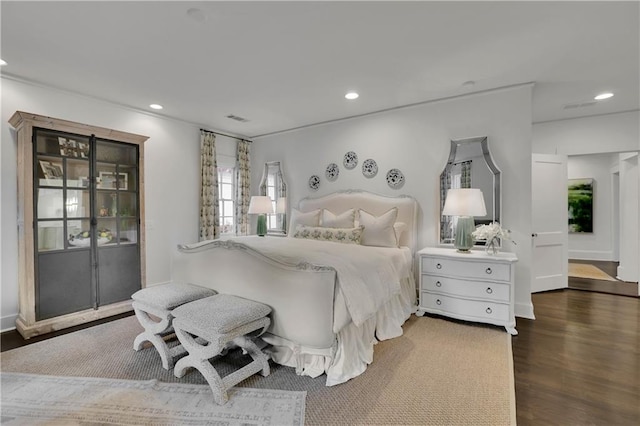 bedroom with dark hardwood / wood-style floors