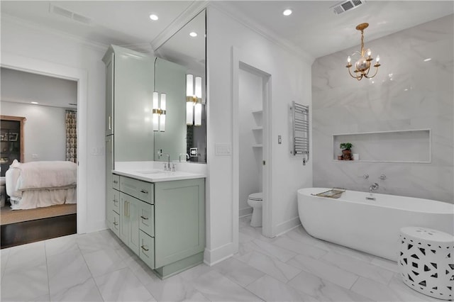 bathroom with crown molding, vanity, a bathtub, and toilet