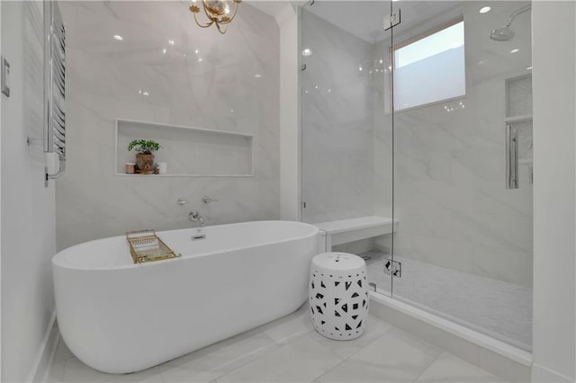 bathroom with tile walls and separate shower and tub