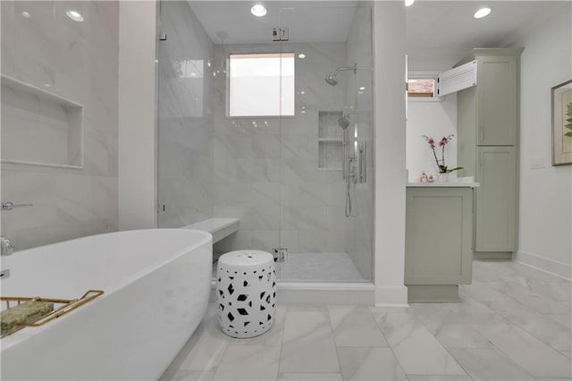 bathroom with vanity and separate shower and tub