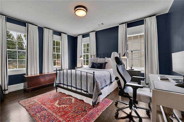 bedroom with dark hardwood / wood-style flooring