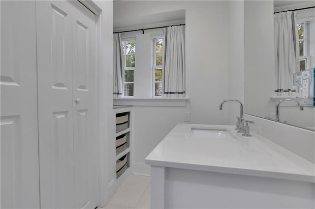 bathroom with tile patterned floors, plenty of natural light, and vanity