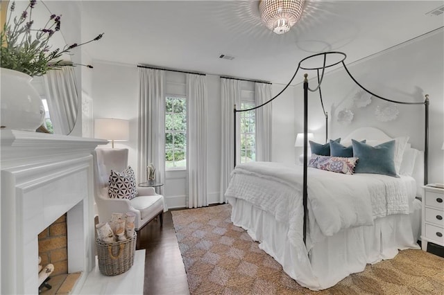 bedroom with hardwood / wood-style flooring and a notable chandelier