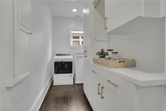 interior space featuring cabinets, washer and dryer, and dark hardwood / wood-style floors