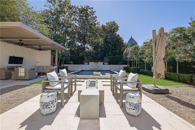 view of patio / terrace featuring a fenced in pool, outdoor lounge area, and ceiling fan