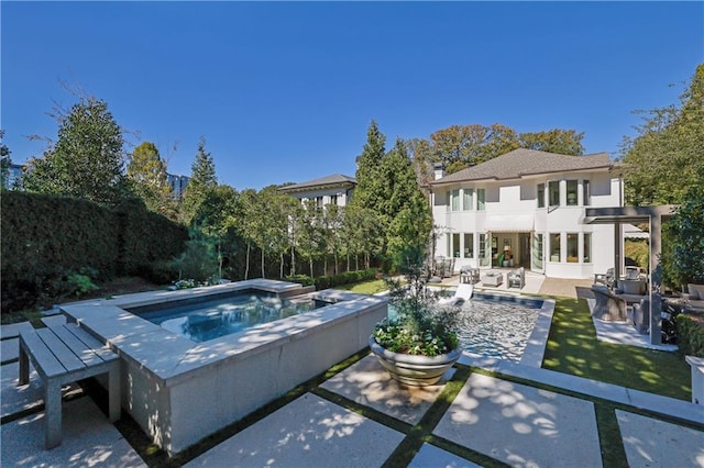 view of swimming pool with an in ground hot tub and a patio