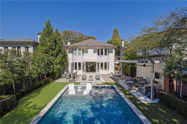 back of property featuring an outdoor living space, a yard, and a patio