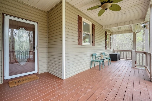wooden terrace featuring a ceiling fan and a porch