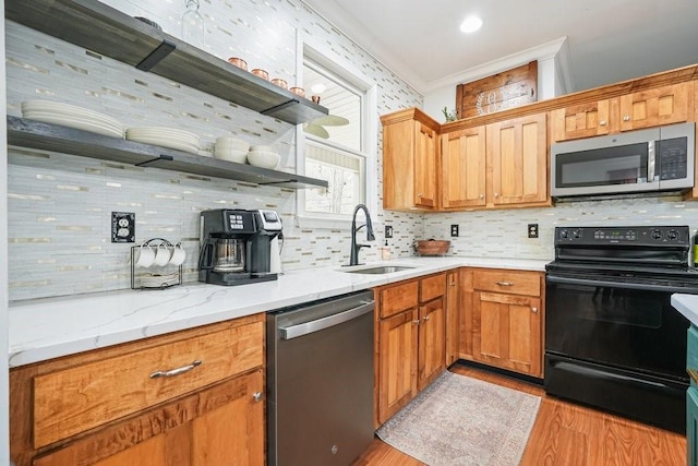 kitchen featuring open shelves, decorative backsplash, a sink, light wood-style flooring, and stainless steel appliances