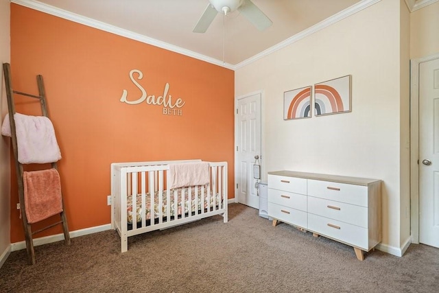 bedroom featuring crown molding, a crib, baseboards, and light colored carpet