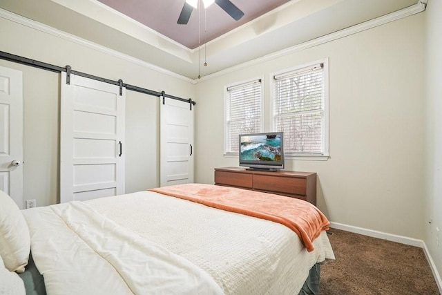 bedroom featuring ceiling fan, a barn door, carpet floors, baseboards, and a tray ceiling