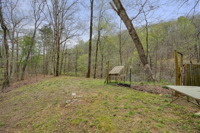 view of yard featuring a forest view