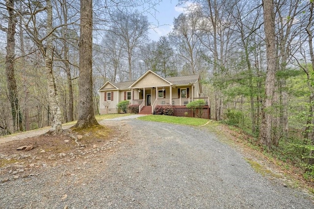 single story home with covered porch and driveway
