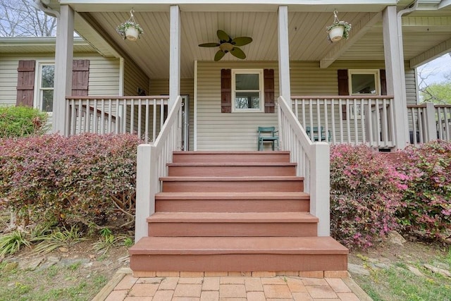 entrance to property with a ceiling fan and covered porch