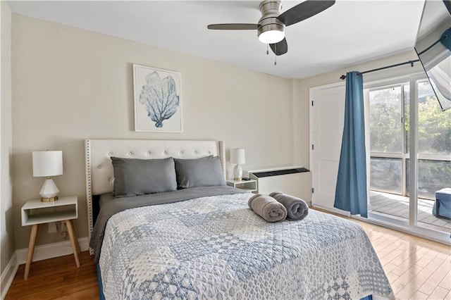 bedroom featuring ceiling fan, wood-type flooring, and access to outside