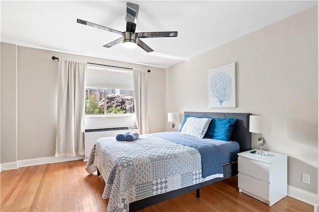 bedroom with ceiling fan and wood-type flooring