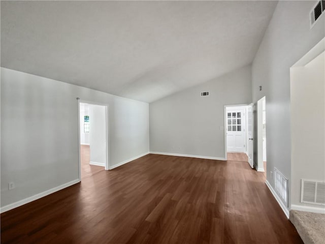 spare room with dark hardwood / wood-style floors and high vaulted ceiling