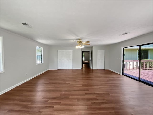 interior space featuring access to exterior, dark hardwood / wood-style flooring, a closet, and ceiling fan