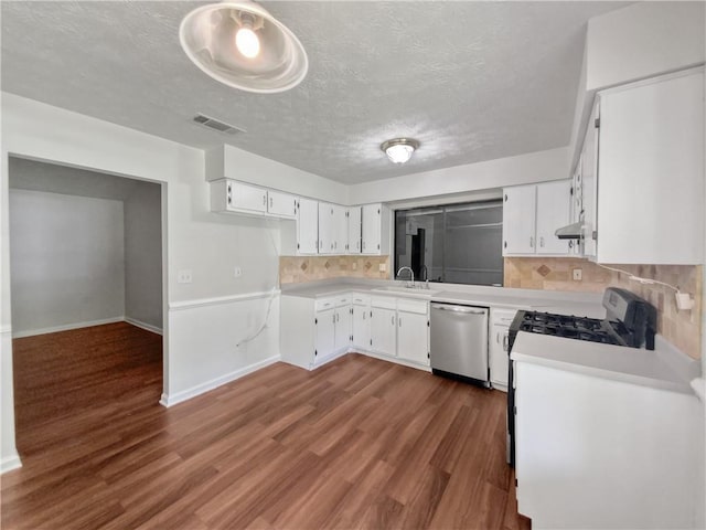 kitchen featuring white cabinets, tasteful backsplash, dark wood-type flooring, sink, and dishwasher