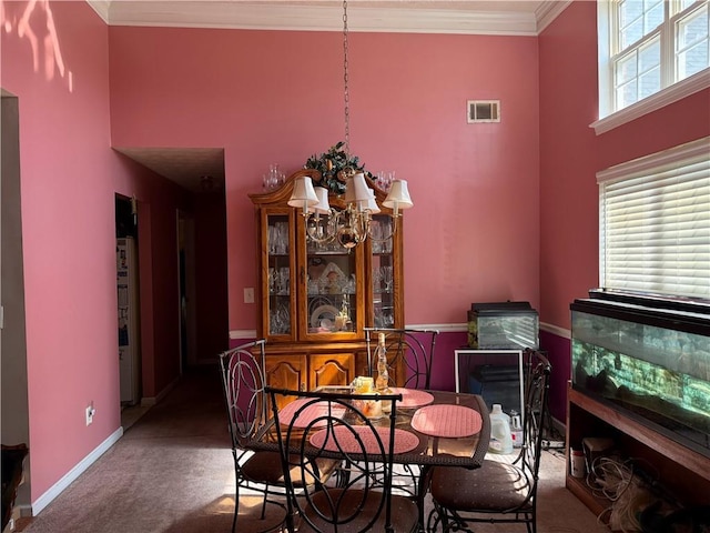 4206 Shoreside Cir, Snellville, GA 30039 - dining area featuring a chandelier, carpet flooring, crown molding, and a towering ceiling