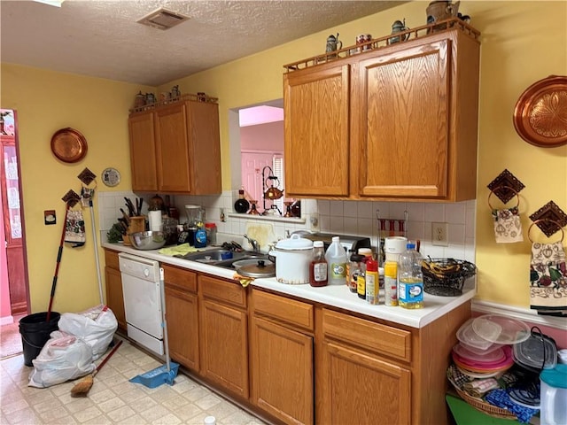 4206 Shoreside Cir, Snellville, GA 30039 - kitchen with white dishwasher, light countertops, backsplash, a textured ceiling, and brown cabinets