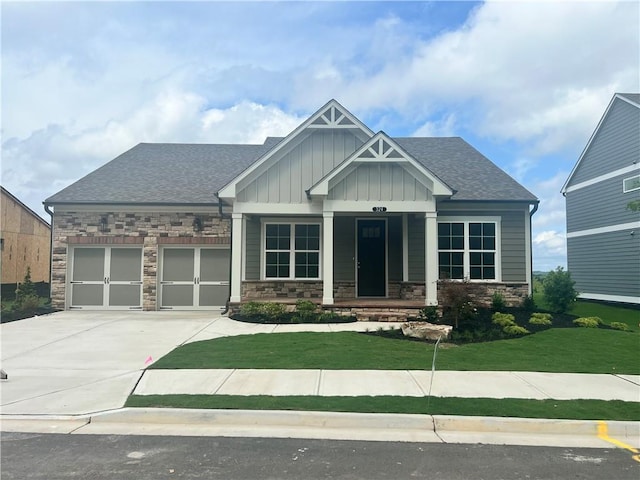 craftsman-style home with a garage and a front yard