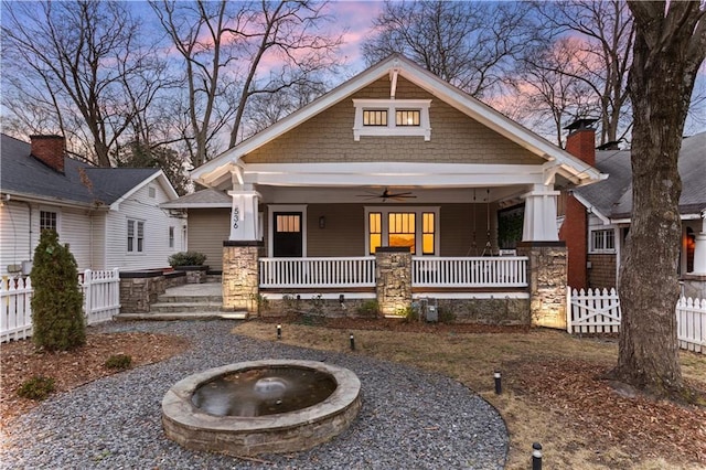 craftsman-style house featuring a porch, a ceiling fan, and fence