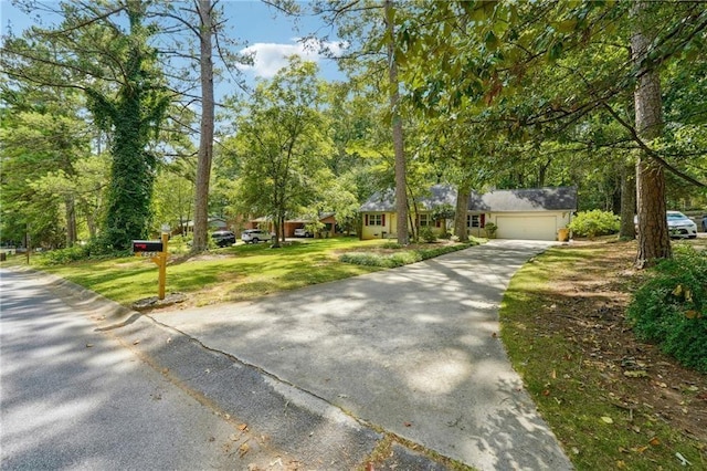 ranch-style house with a garage and concrete driveway