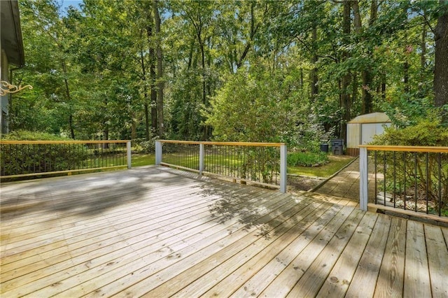 wooden terrace with an outbuilding and a storage unit