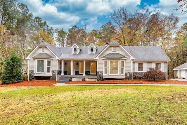 view of front facade with covered porch and a front lawn