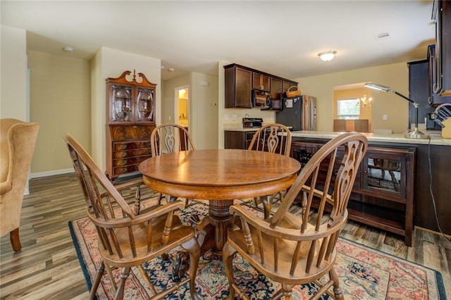 110 Baltusrol Way, Covington, GA 30014 - dining room with light wood-style floors and baseboards