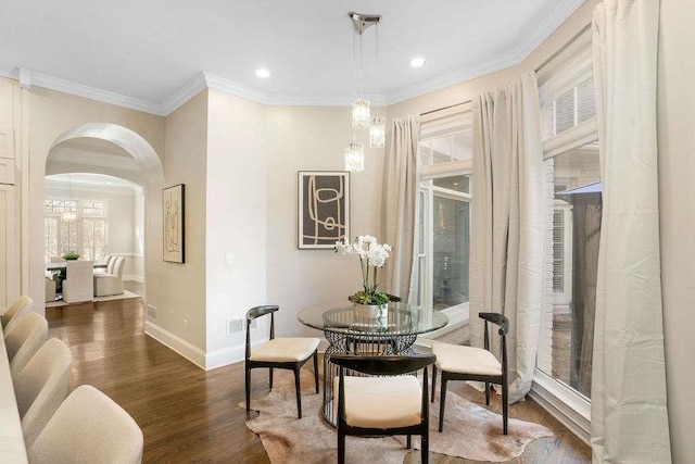 living area with dark hardwood / wood-style flooring and ornamental molding