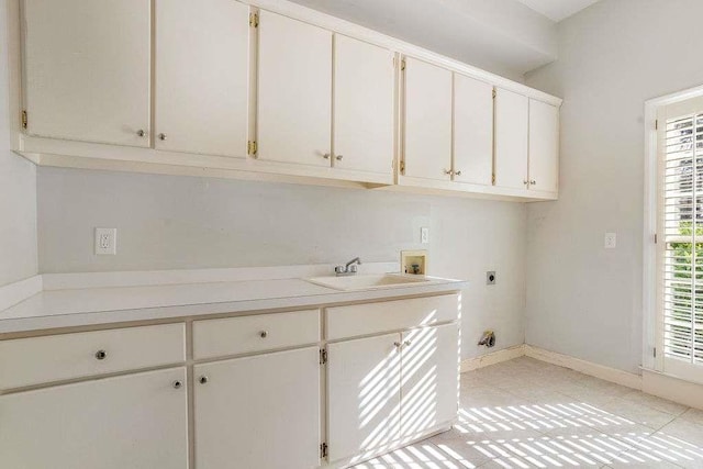 washroom with sink, cabinets, washer hookup, electric dryer hookup, and light tile patterned floors