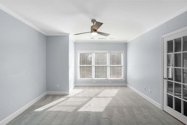 spare room with light colored carpet, ceiling fan, and crown molding