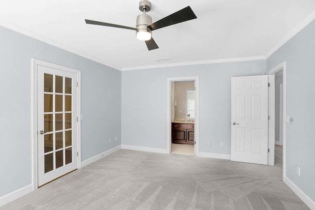 carpeted spare room with ceiling fan and ornamental molding