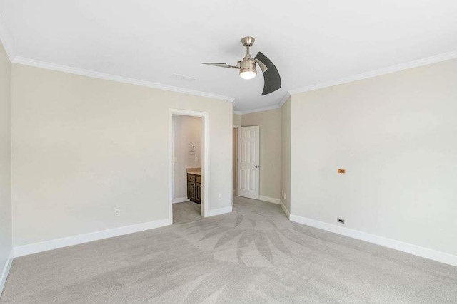 unfurnished bedroom featuring connected bathroom, ceiling fan, crown molding, and light colored carpet