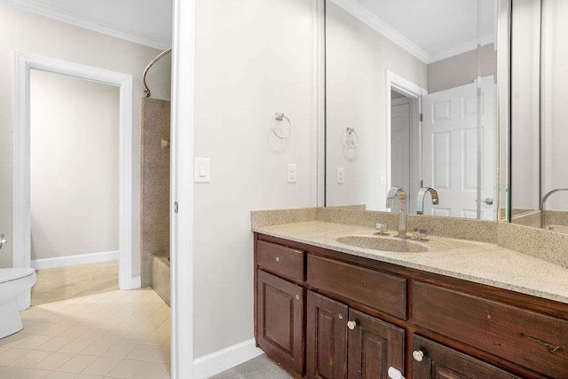 bathroom with vanity, toilet, and crown molding