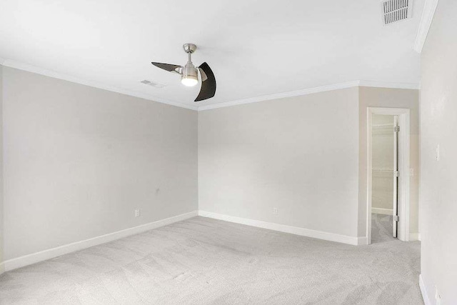 carpeted empty room with ceiling fan and ornamental molding